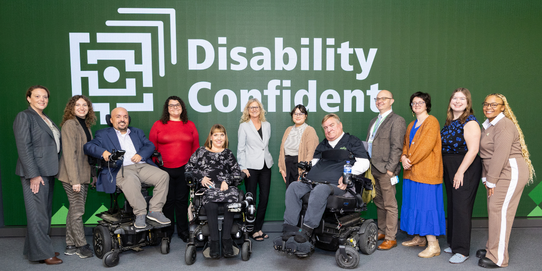 The Starkloff staff smiling onstage. The background is Starkloff’s Disability Confident logo.