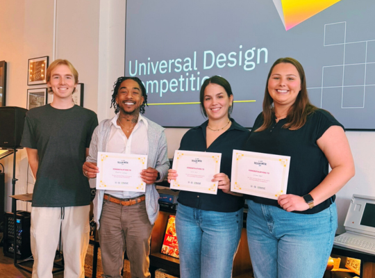 STLCC Students in STLDesignWeek UD Competition 2025 – landscape College students, 3 holding certificates, smile together in an office with screen behind them.